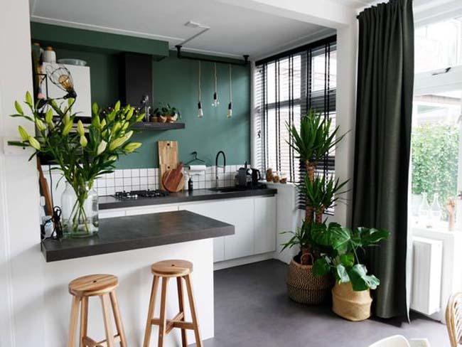 Una cocina pintada de verde oscuro