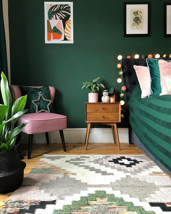 Un dormitorio que combina color verde en paredes y rosa