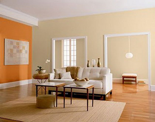 Un salón pintado de naranja con muebles blancos